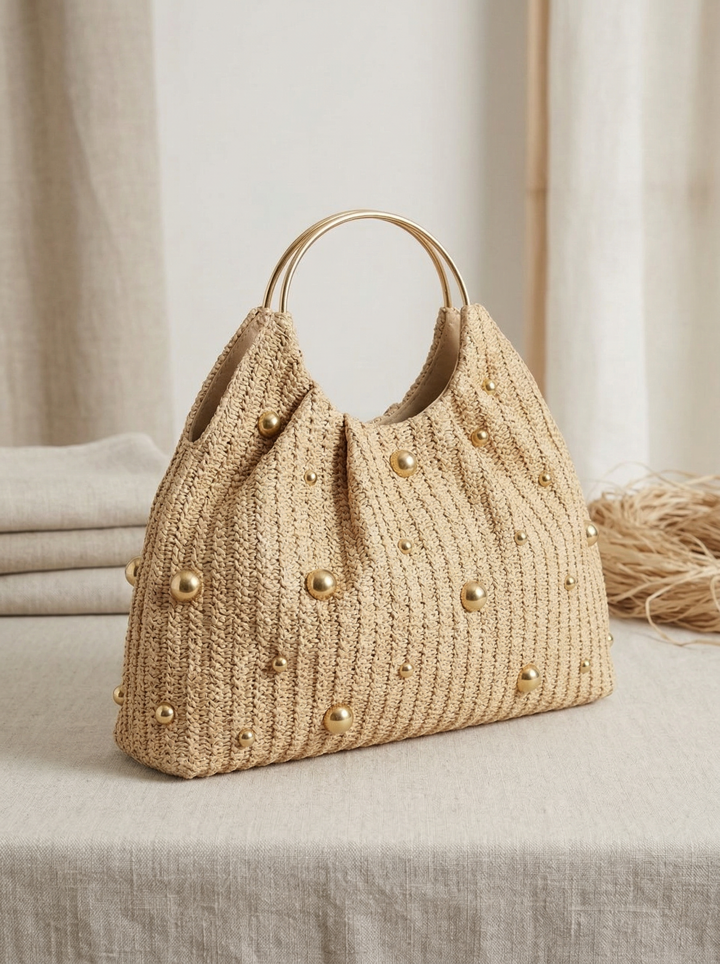 Artisanal Studded Handwoven Raffia Bag with Sculptural Gold Ring Handle